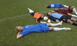 exhausted_kickers_lying_on_soccer_field_d4mo7-98